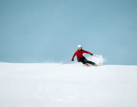 A skier gracefully gliding down the snow-covered slopes of Pal Arinsal – La Massana ski resort in Andorra encapsulating the exhilaration and beauty of winter sports.