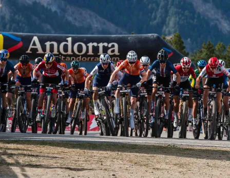 A mountain biker in action at Pal Arinsal – La Massana in Andorra. A chalet and snowy mountains form the picturesque backdrop of this winter sports scene.