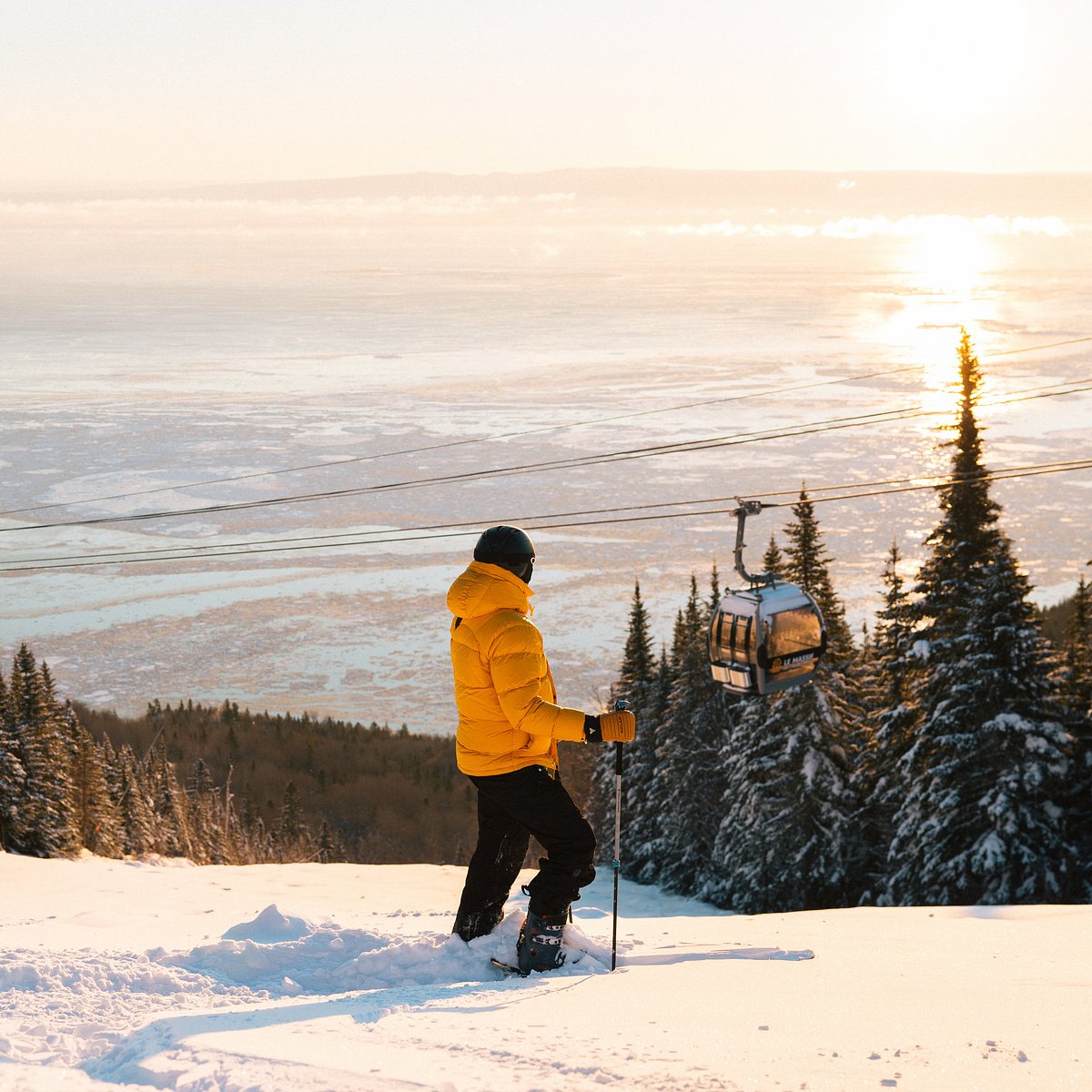 Le Massif de Charlevoix in Canada - a person riding a ski board on a snowy slope.