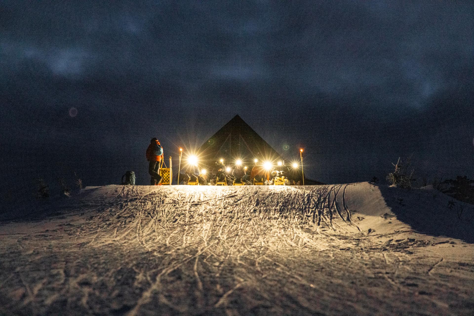 Le Massif de Charlevoix in Canada - a group of people standing on top of a snow covered hill.