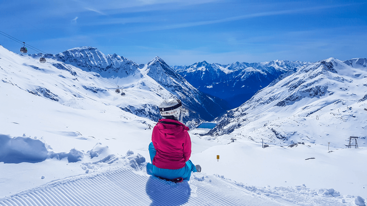 Moelltal Glacier in Austria - a person sitting on a snowboard in the snow.