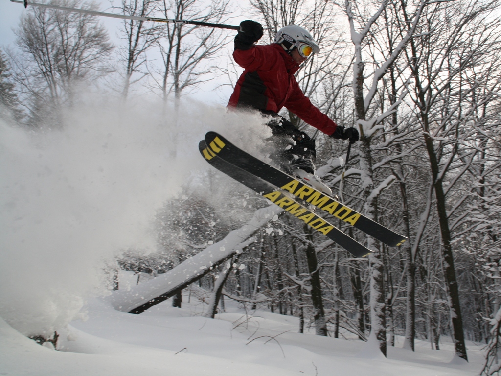 Komáří vížka – Horní Krupka in Czech Republic - a person jumping in the air on a snowboard.