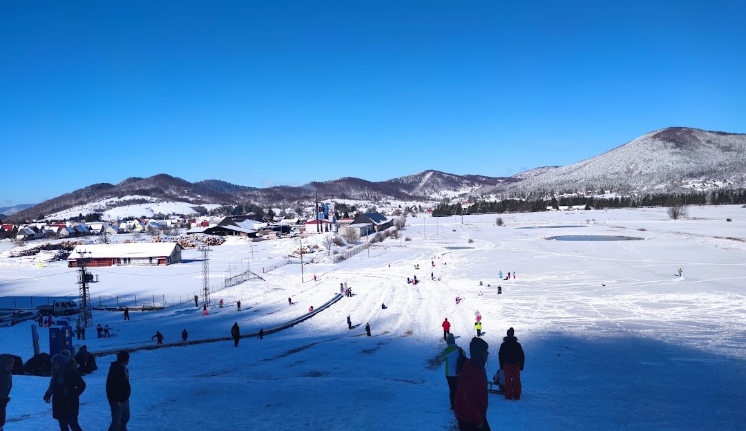 Čelimbaša in Croatia - a group of people standing on top of a snow covered slope.