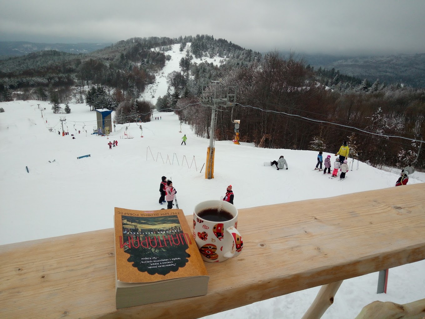 Ossogovo in Bulgaria - a cup of coffee sitting on top of a wooden table.