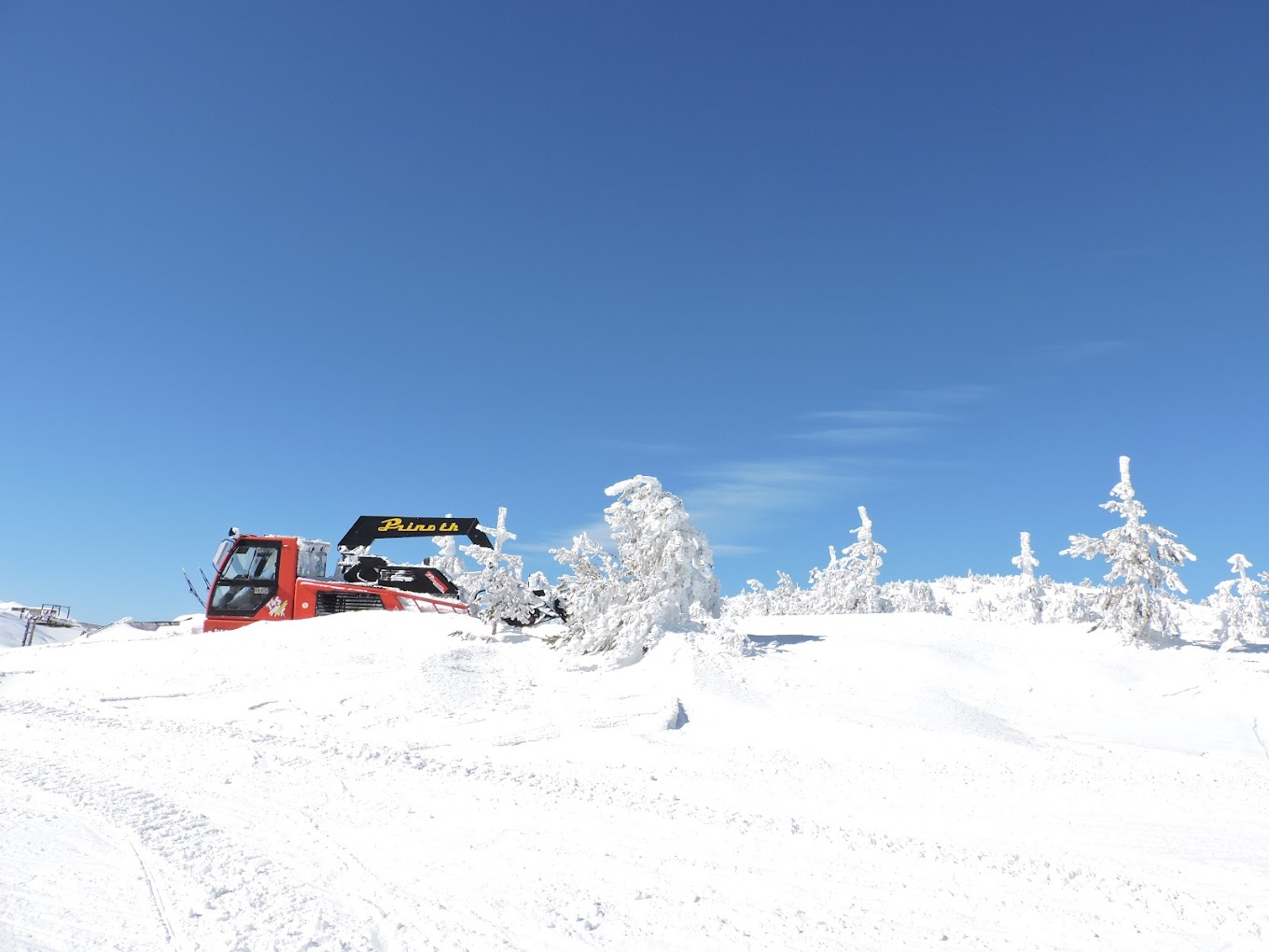 Ossogovo in Bulgaria - a red truck is parked in the snow.