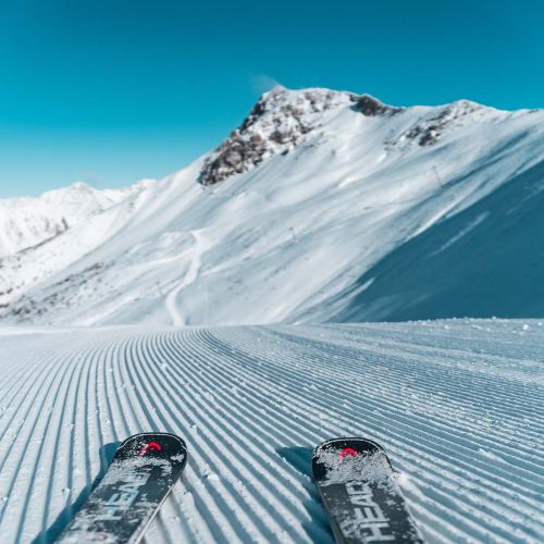 Skiers enjoying winter sports at Les Orres ski resort in Gap, France. The slopes are blanketed in snow, creating a picturesque winter scene.