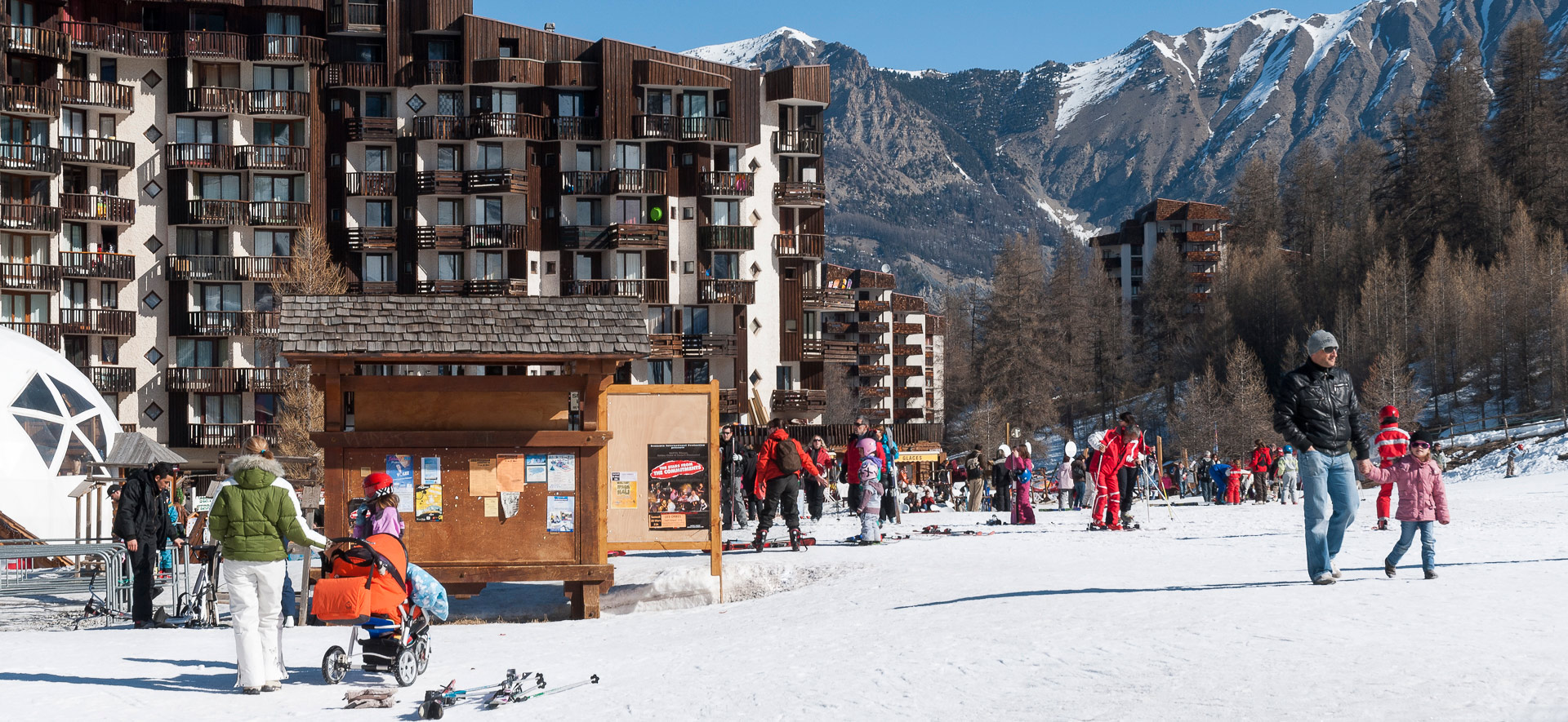 Les Orres in France - a group of people skiing down a snow covered hill.