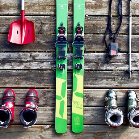Winter sports scene at Les Orres in Gap, France showcasing snow-covered slopes with skiers and snowboarders in action, and a charming chalet nestled amongst the snow.