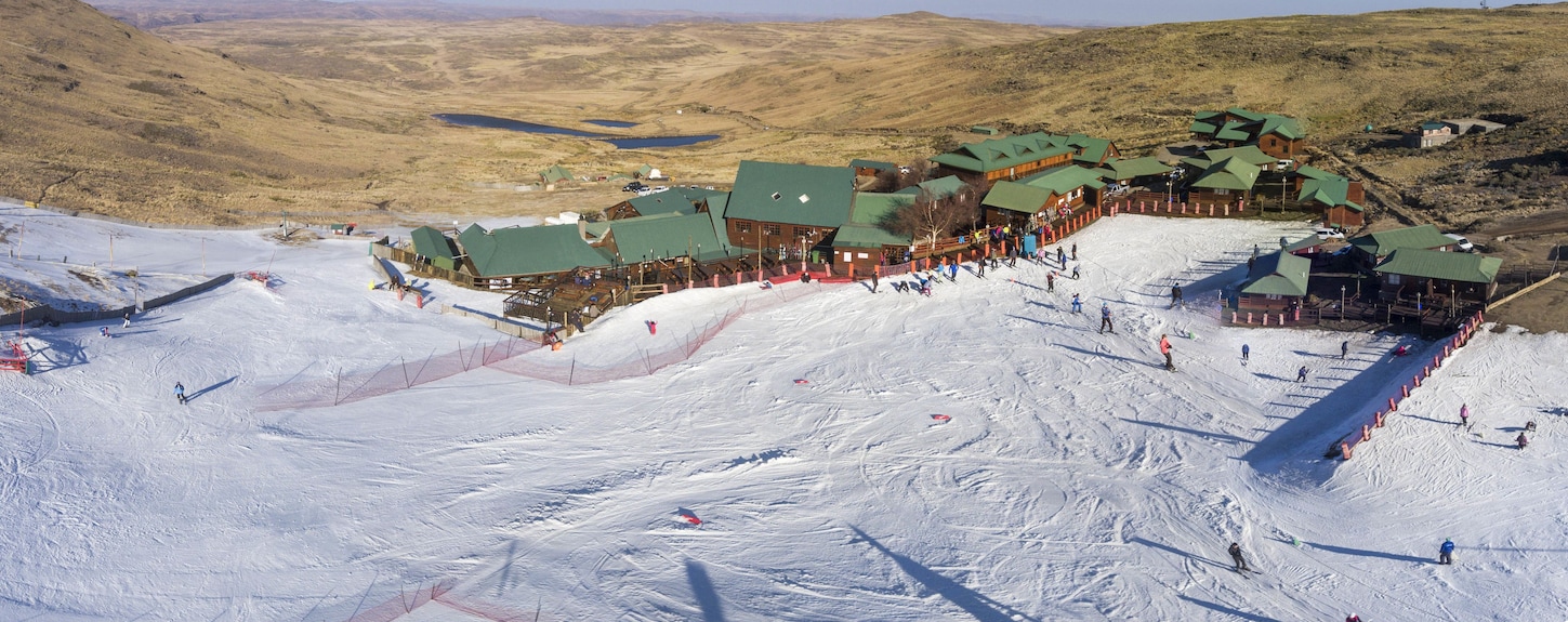 Tiffindell in South Africa - a group of people skiing down a mountain.