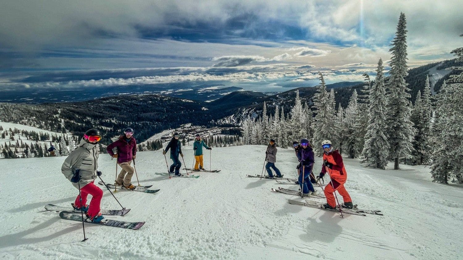 Schweitzer Mountain Resort in USA - a group of people skiing down a snow covered mountain.