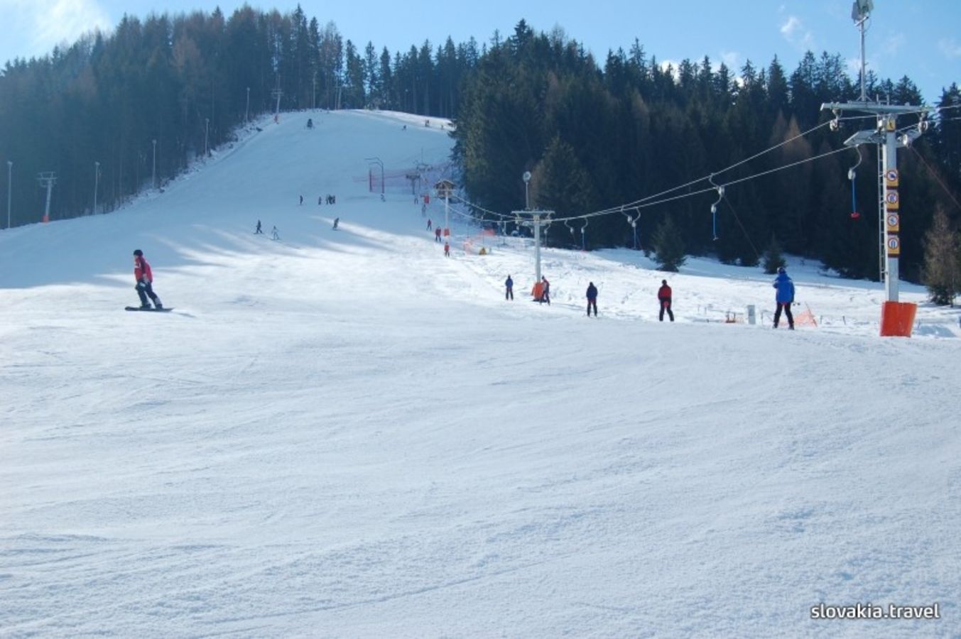 Žiarce – Pavčina Lehota in Slovakia - a group of people skiing down a snowy slope.