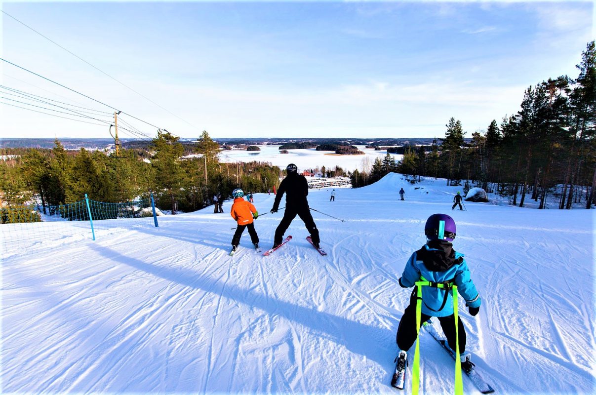 Ellivuori in Finland - a group of people skiing down a hill.