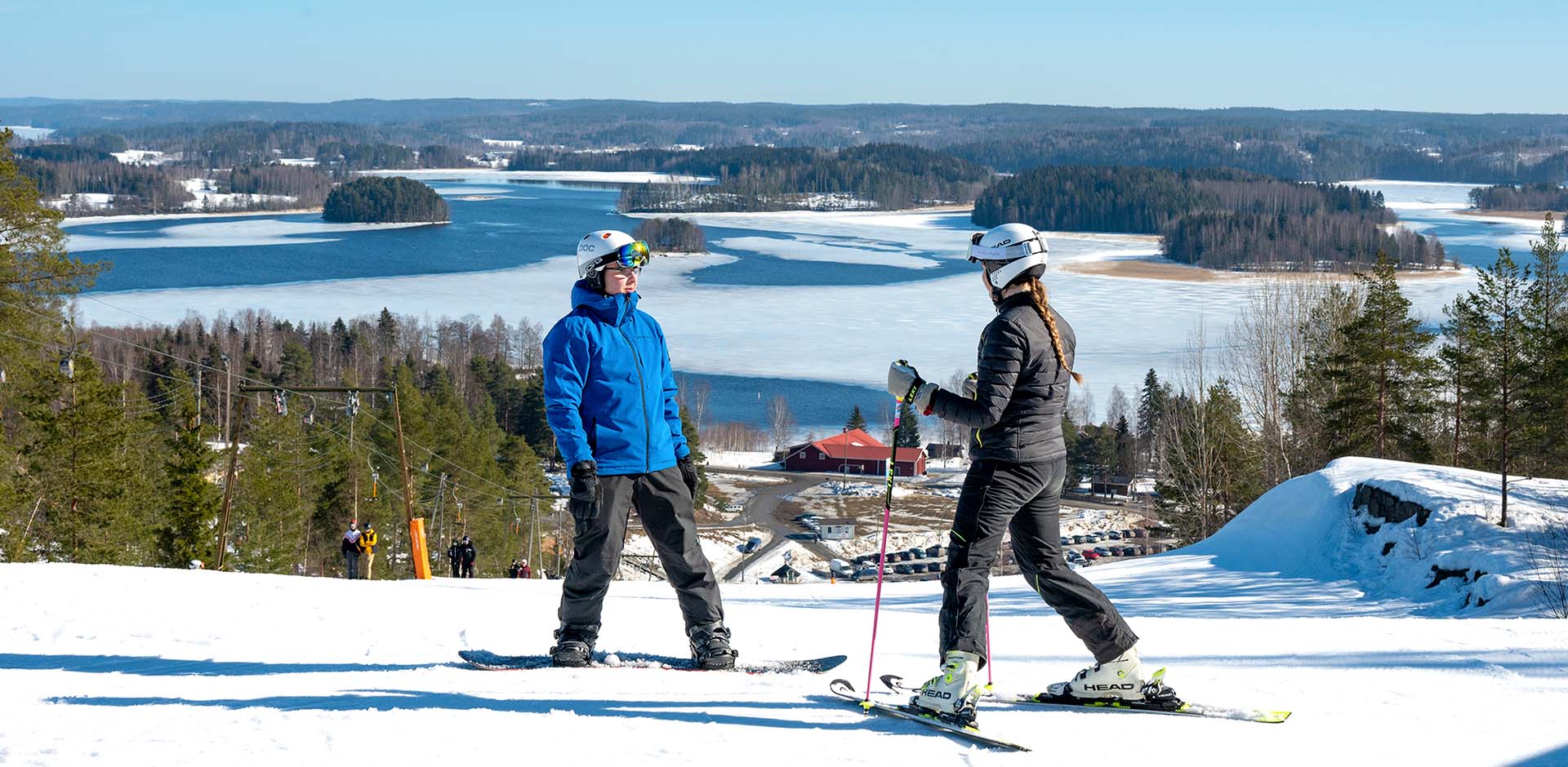 Ellivuori in Finland - two people standing on top of a snow covered hill.