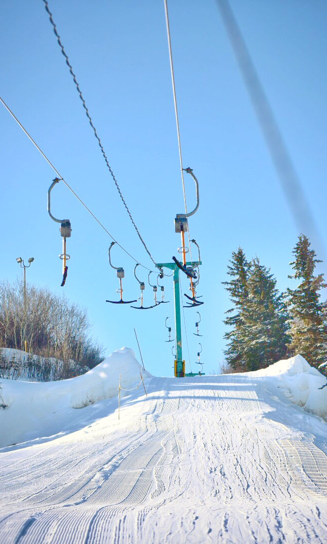 Valley Ski Hill – Alliance in Canada - a ski lift going up a snowy hill.