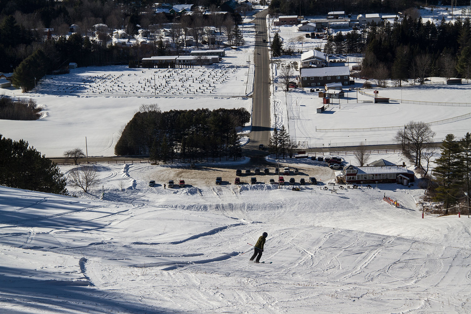 Lyndon Outing Club in USA - a person skiing down a hill in the snow.