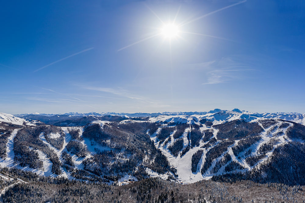 Winter sports enthusiasts enjoying at the Kolašin ski resort in Montenegro, amongst stunning mountain landscapes covered in a blanket of snow.