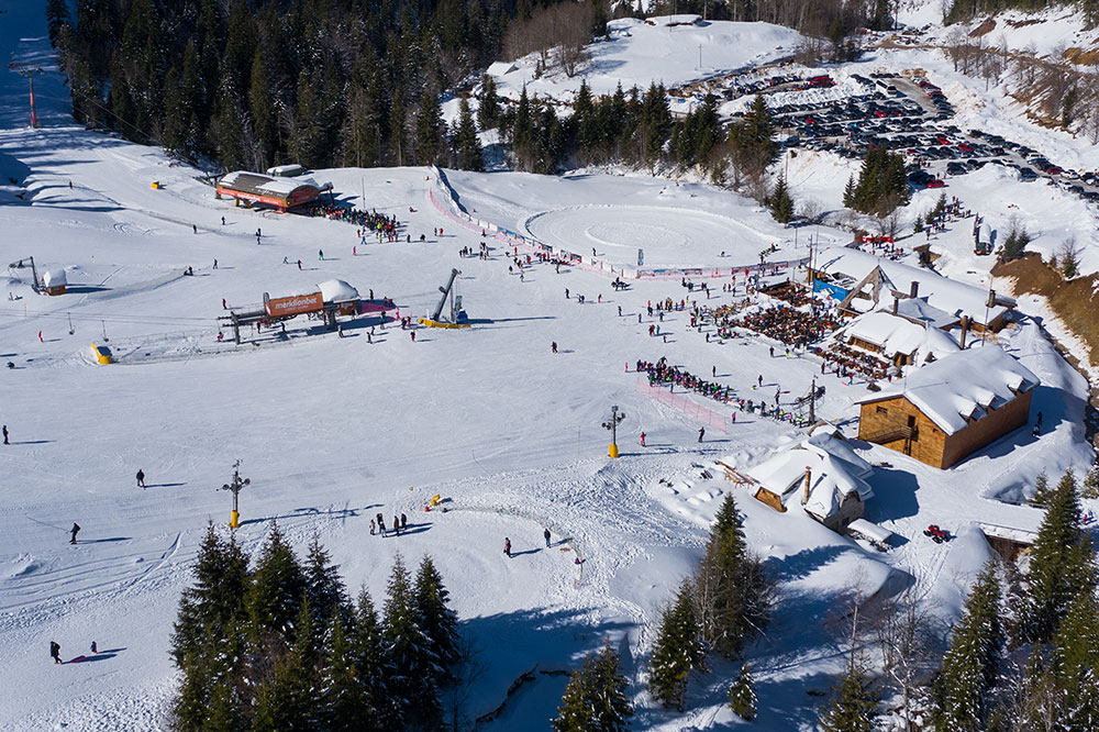 Scenic view of the Kolašin 1450 | Kolašin 1600 ski resort in Montenegro, featuring a winter sports scene with skiers and a ski lift.