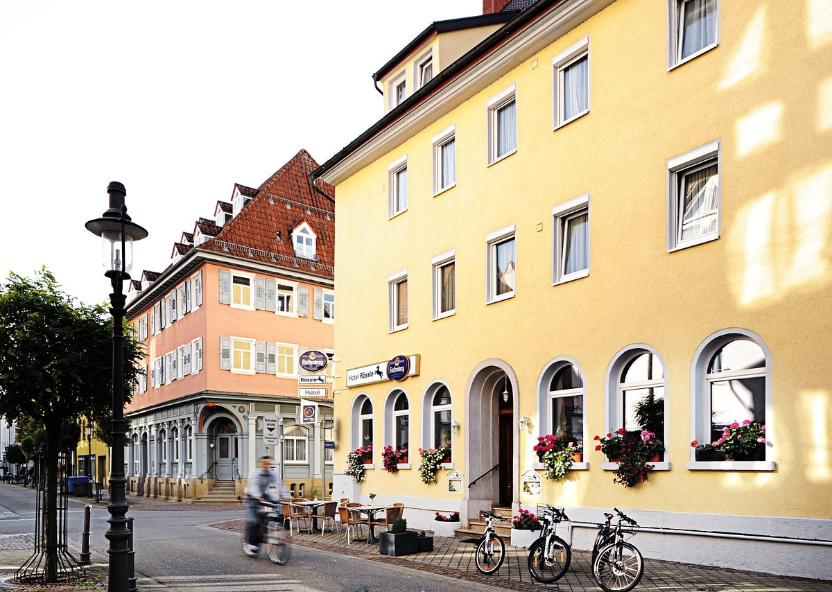 Antoni – Fridingen an der Donau in Germany: a bicycle parked in front of a yellow building.