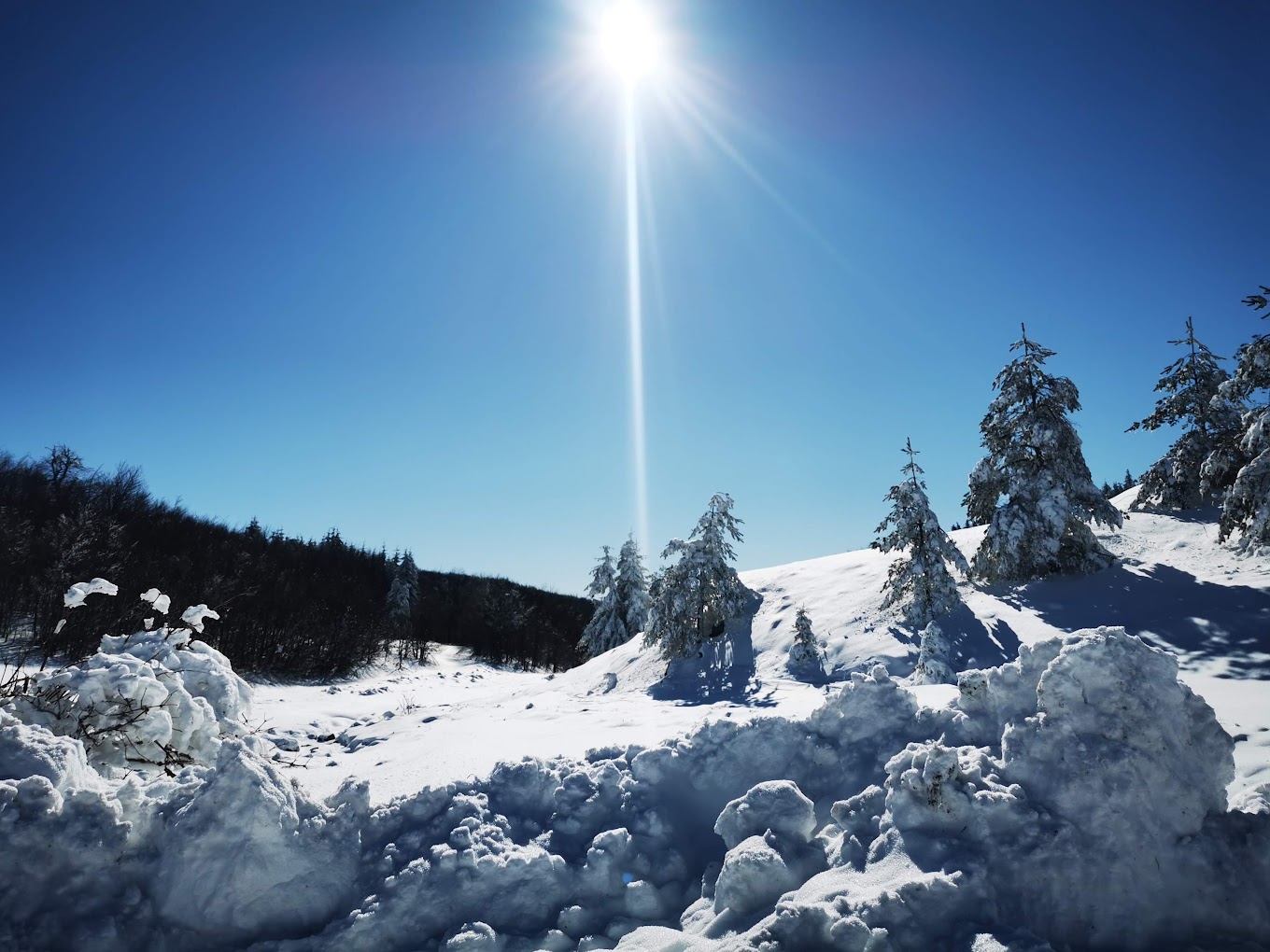 Uzana in Bulgaria - the sun is shining over a pile of snow.