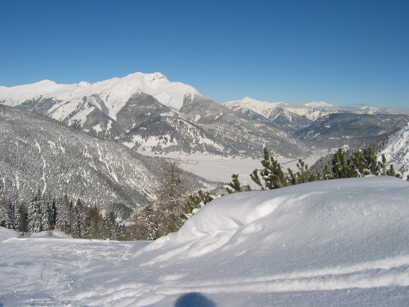Marienbergbahnen Biberwier in Austria - a person standing on top of a snow covered mountain.