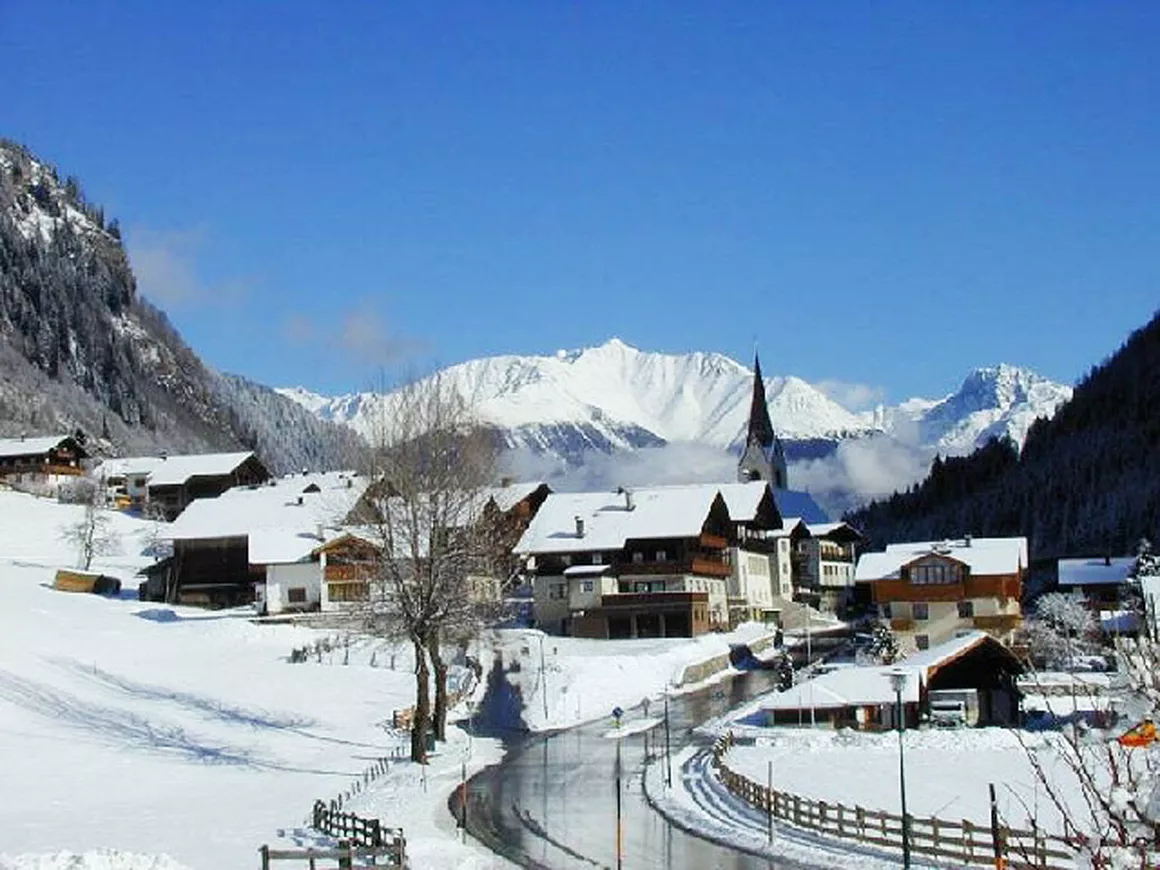 Skizentrum St. Jakob in Austria - a snowy village with mountains in the background.