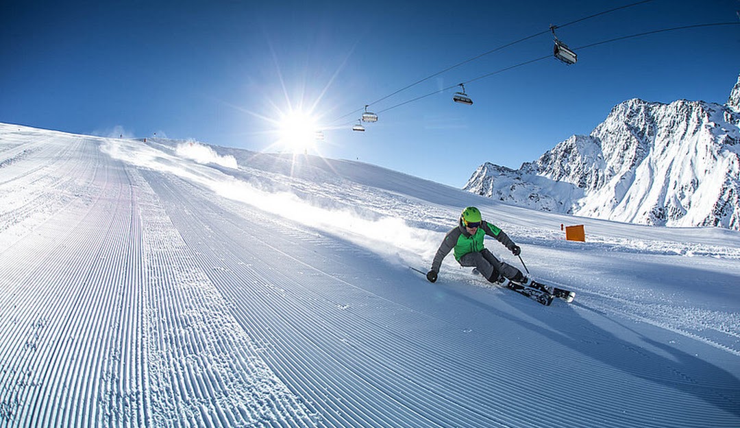Skizentrum St. Jakob in Austria - a person riding a snowboard down the side of a mountain.