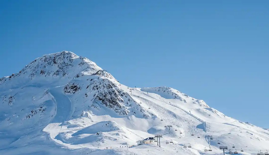 Skizentrum St. Jakob in Austria - a snow covered mountain with a ski lift in the background.