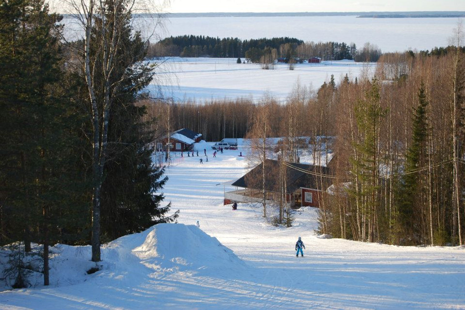 Lakis in Finland - a person skiing down a hill in the snow.