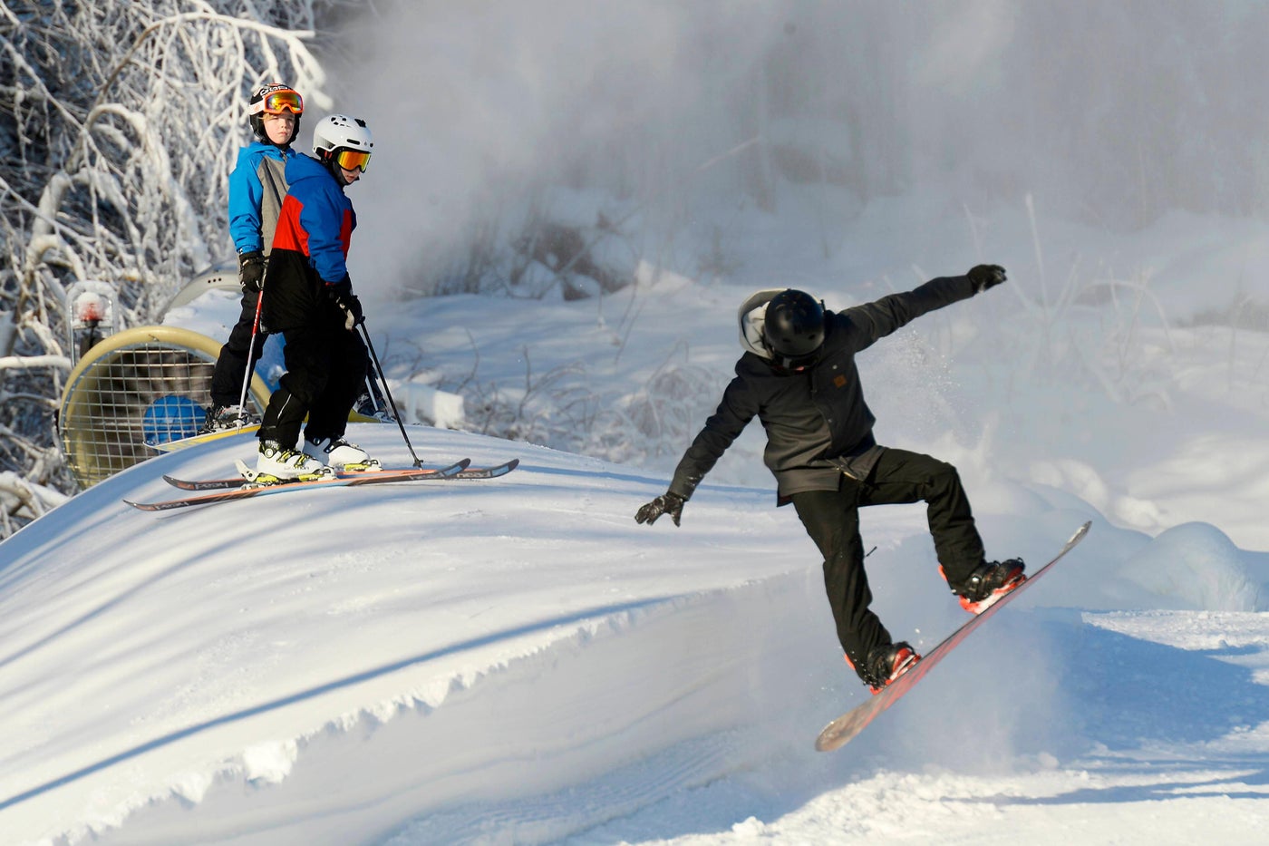 Sundsvall – Sidsjöbacken in Sweden - two people are skiing down a snowy hill.