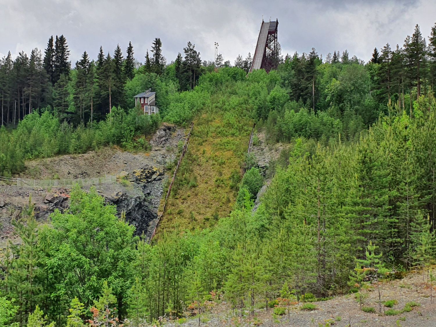 Hedebacken in Sweden: a large hill with trees and a building on top.