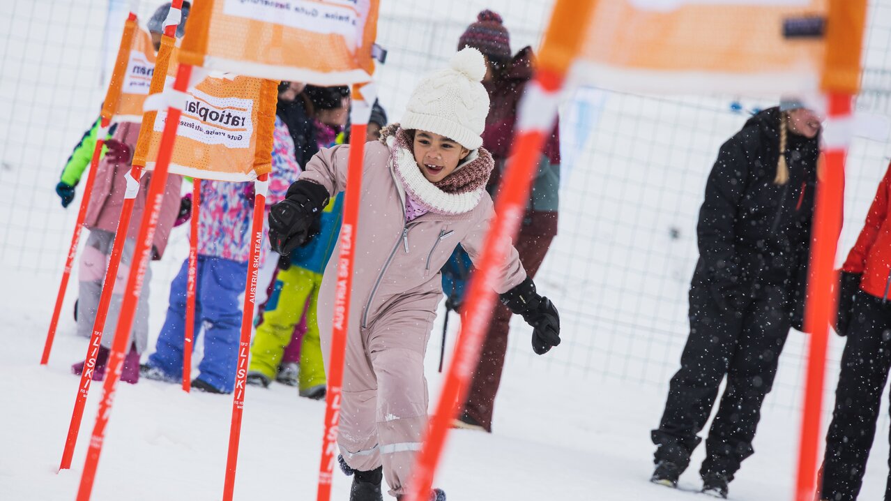 Pirstingerkogellift Sommeralm in Austria - a young girl is running in the snow.