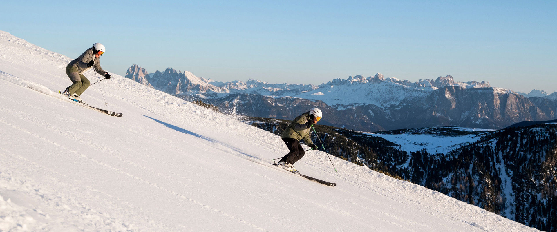 Reinswald in Italy - two people skiing down a snow covered mountain.