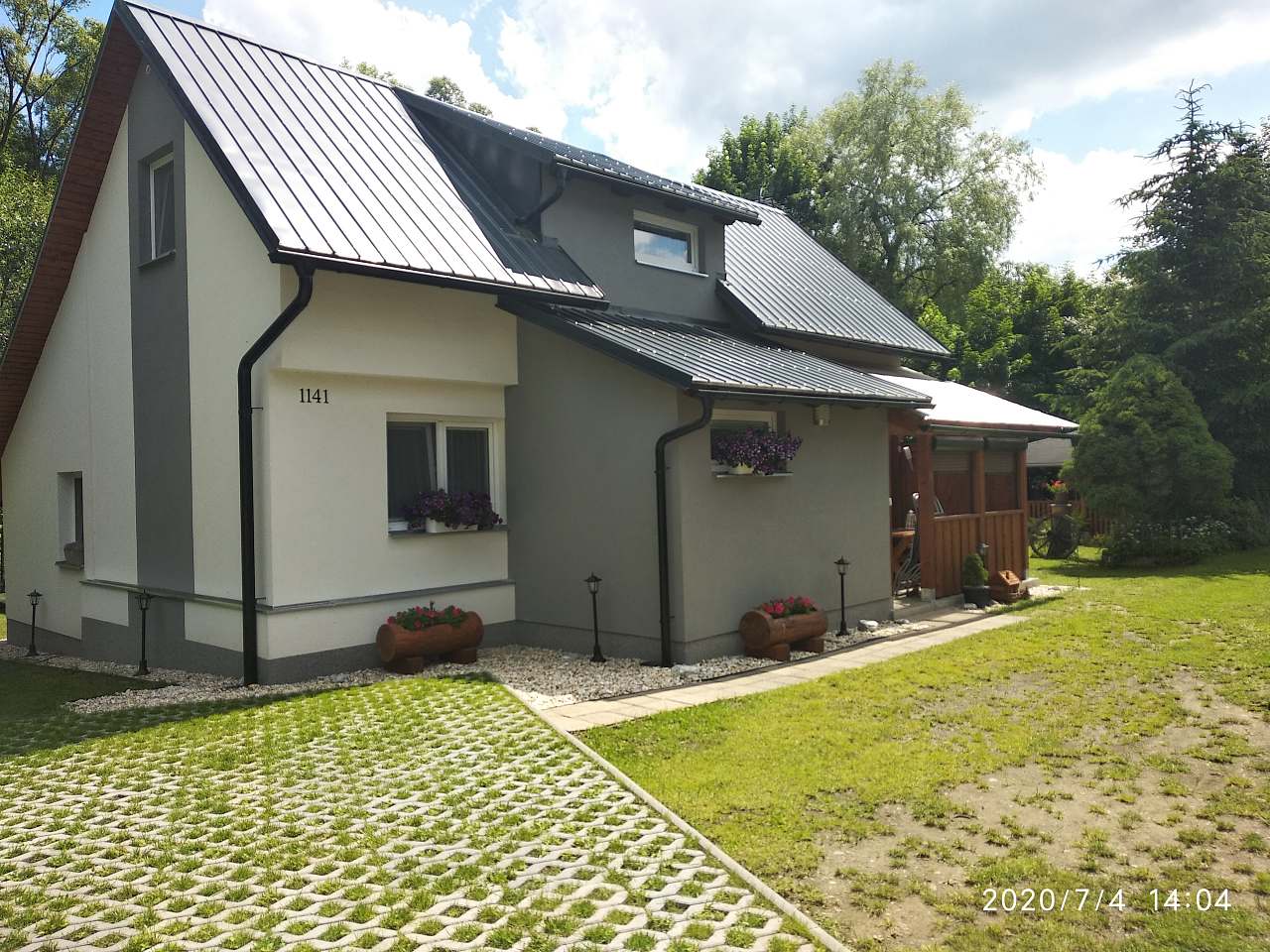 Machůzky in Czech Republic - a house with a metal roof in the countryside.