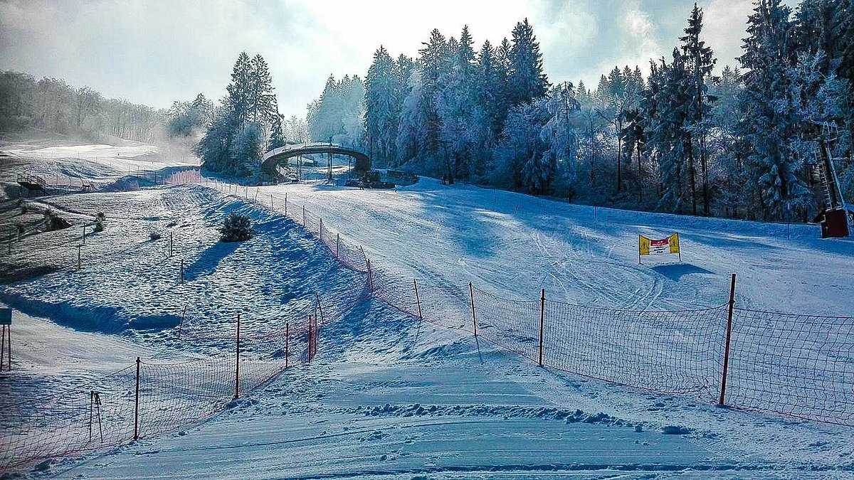 Celjska koča in Slovenia - a snow covered ski slope with trees in the background.