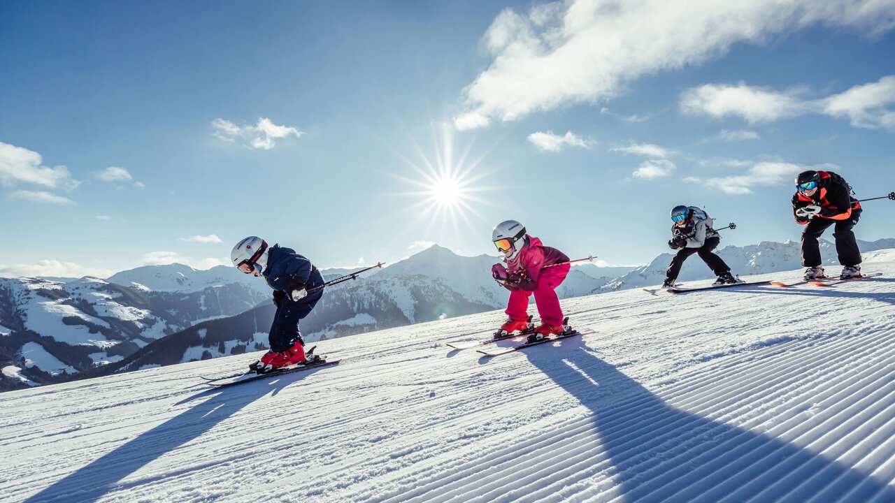 Roggenboden in Austria - a group of people skiing down a snowy slope.