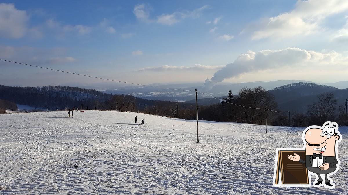 Schafmatt – Oltingen in Switzerland - a snow covered ski slope with a person standing in the snow.