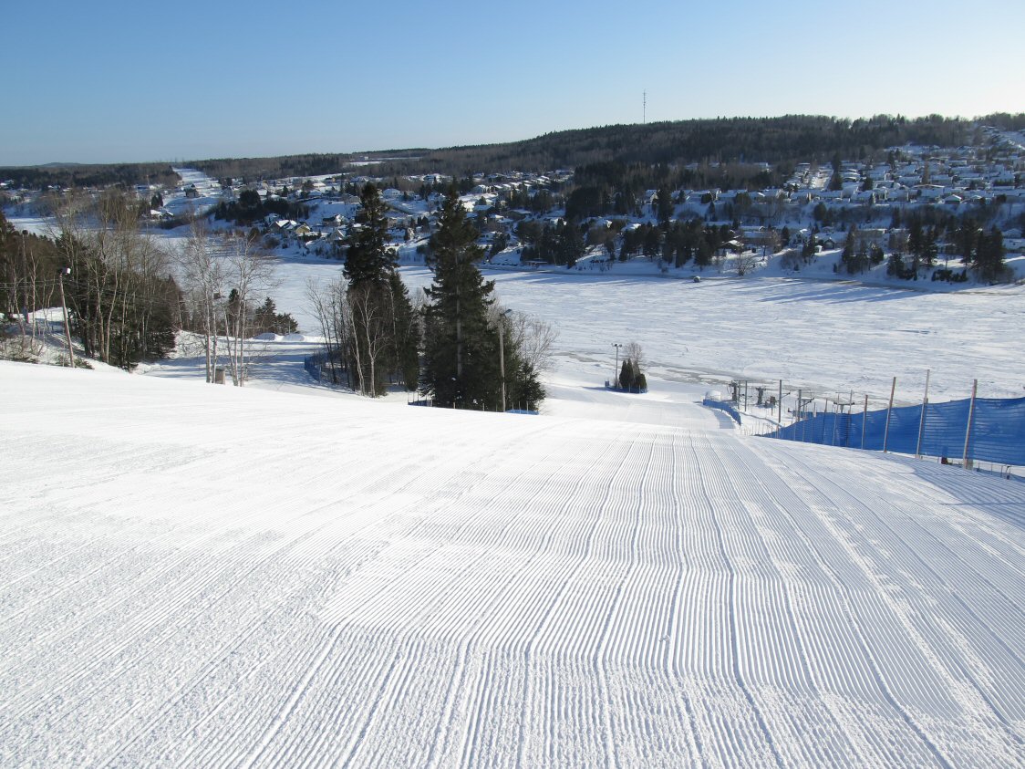 Mont Villa Saguenay in Canada - a snow covered ski slope with trees in the background.