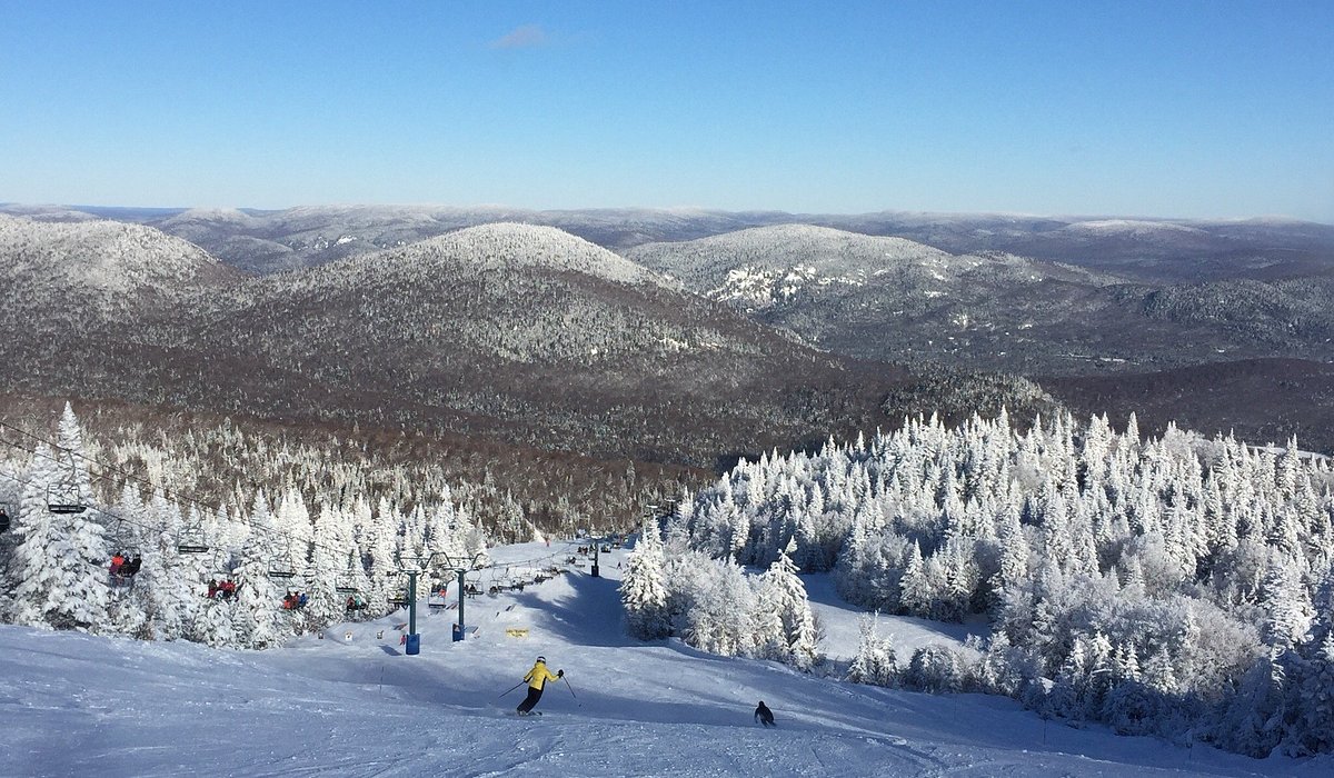 Mont Villa Saguenay in Canada - a group of people skiing down a snowy mountain.