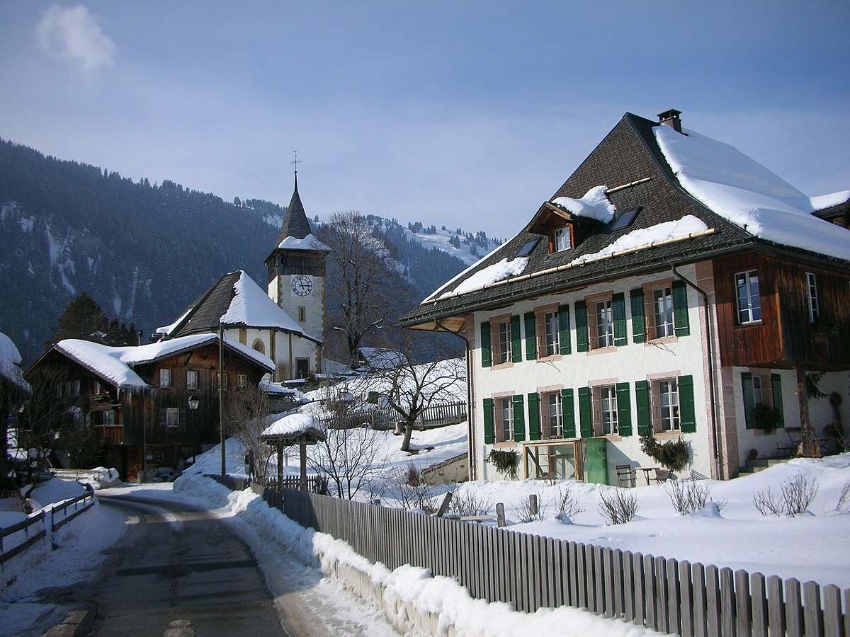 Lauenen in Switzerland - a snow covered street in a small town.