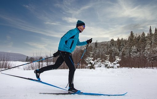 Ekebyhovsbacken – Ekerö in Sweden - a man riding skis down a snow covered slope.