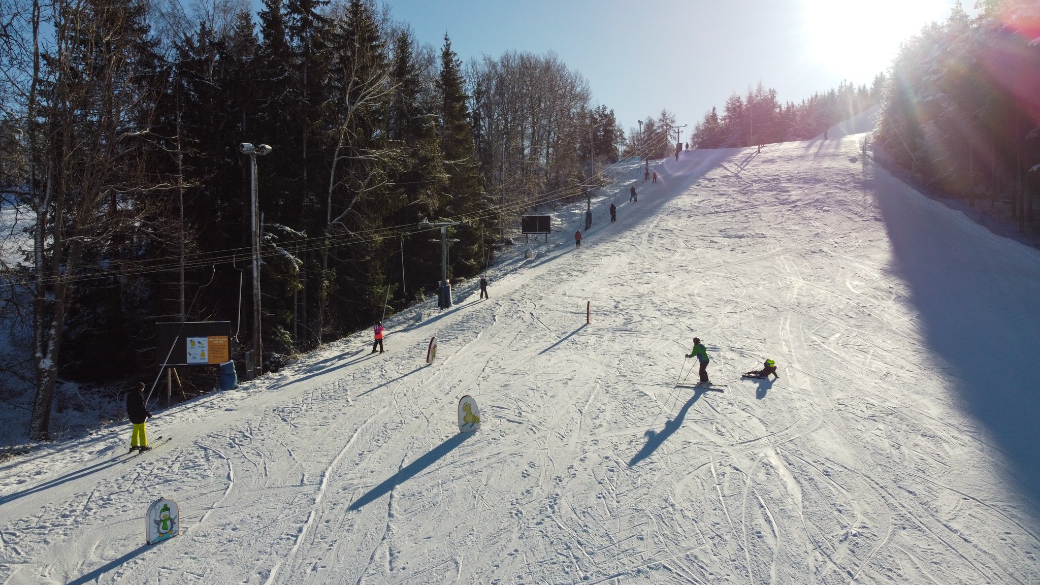 Ekebyhovsbacken – Ekerö in Sweden - a group of people skiing down a snowy slope.