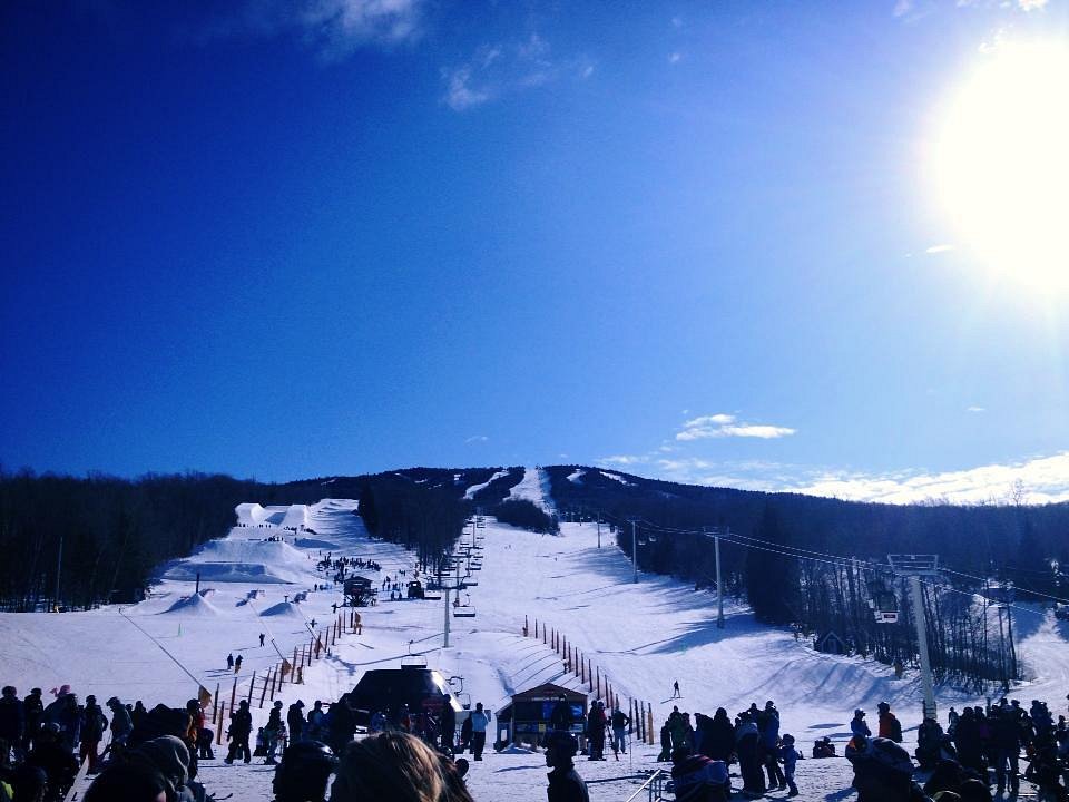 Stratton Mountain Resort in USA - a group of people standing on top of a snow covered slope.