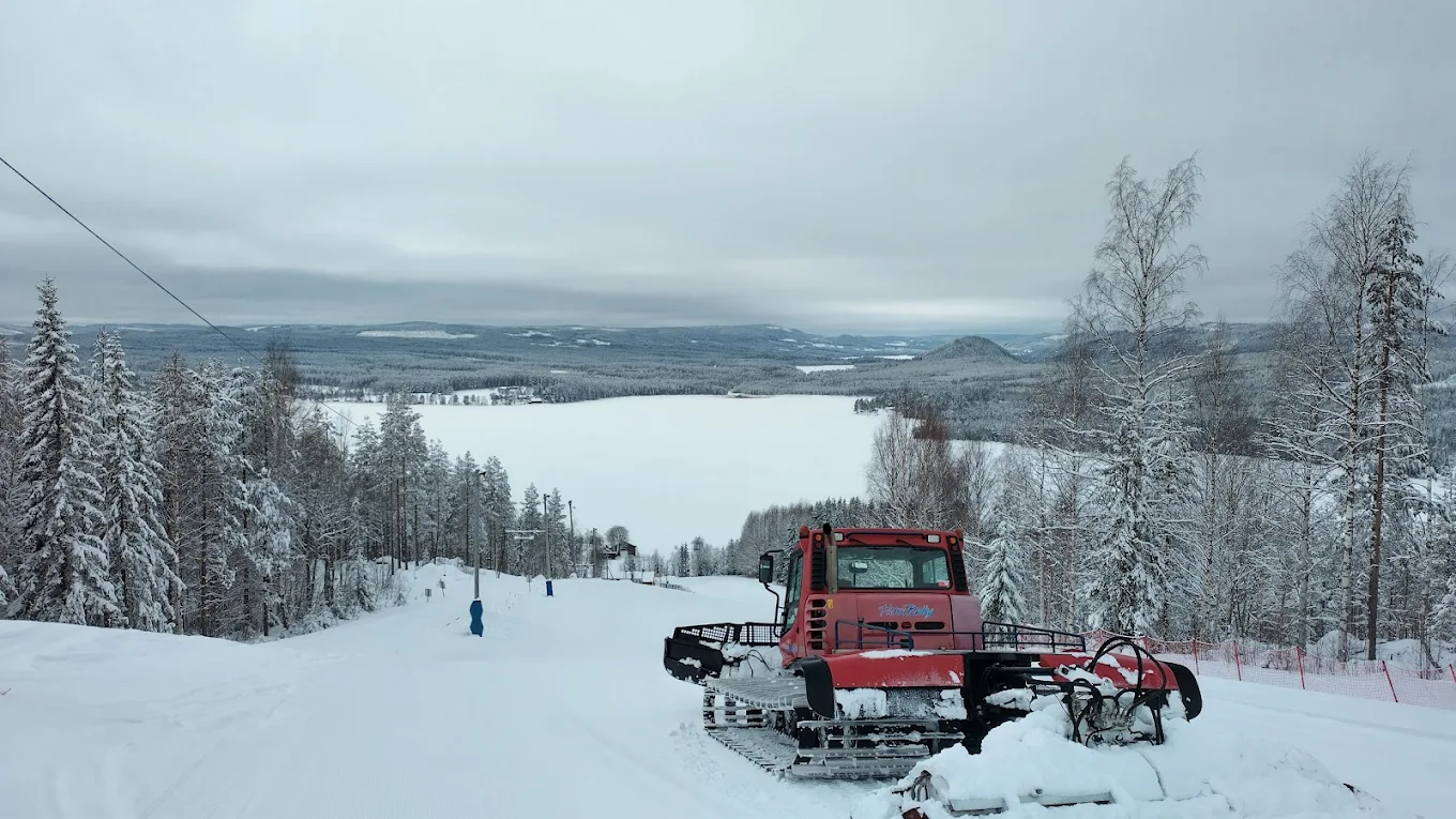 Svedjebacken in Sweden - a snow pling machine is parked on the side of a mountain.