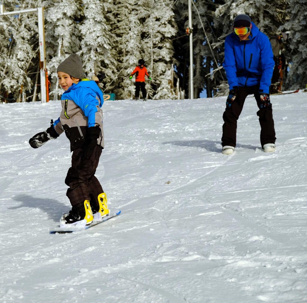 Hurricane Ridge in USA - a group of people riding down a snow covered slope.
