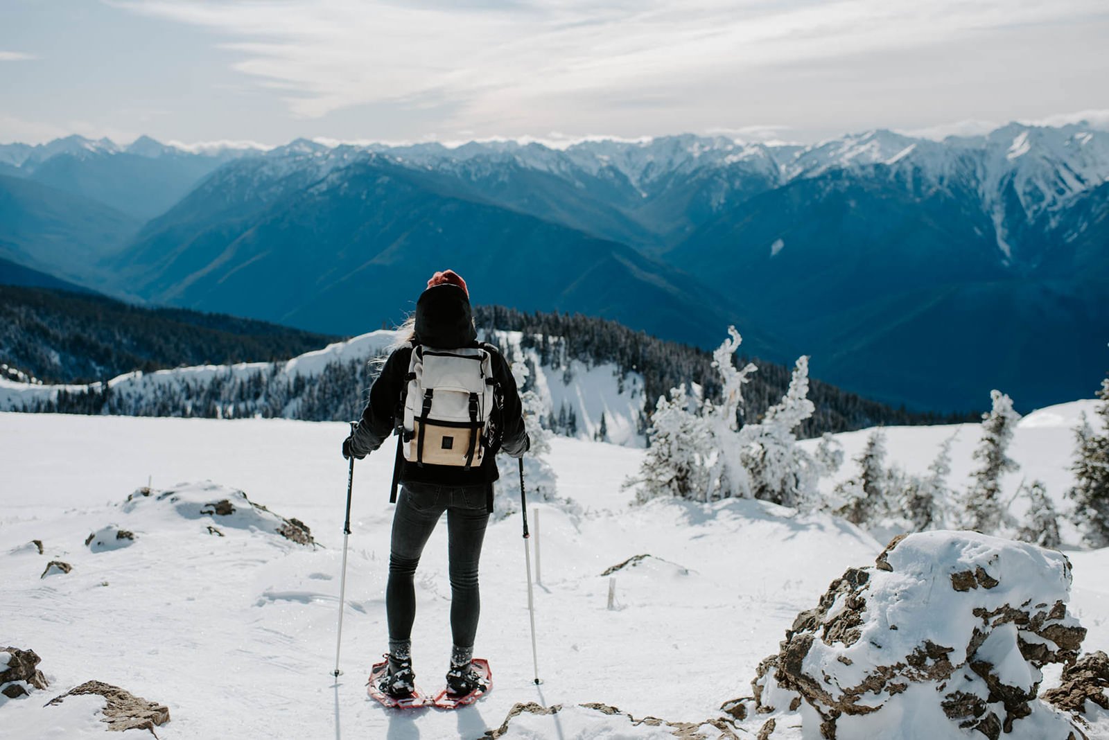 Hurricane Ridge in USA - a person standing on top of a snow covered mountain.