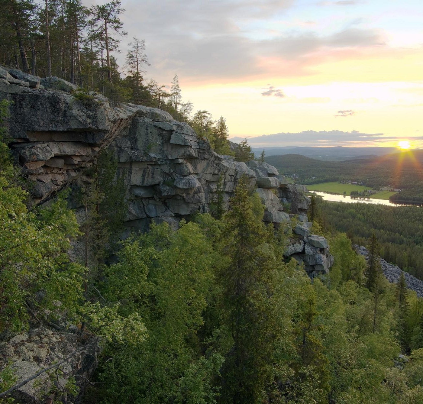 Aavasaksa in Finland - the sun is setting over the mountains and trees.