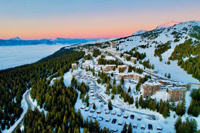 Ski resort scene in Chamrousse, Grenoble, with a quaint chalet nestled amidst snowy slopes, offering winter sports activities amidst stunning winter scenery.