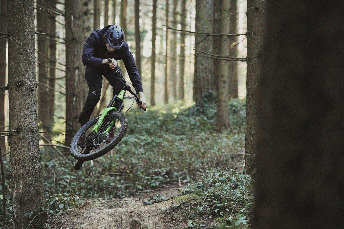 Sauerberg – Frammersbach in Germany - a man riding a bike through a forest.