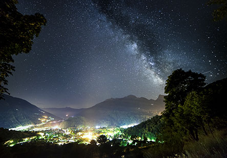 Beautiful winter scene in Bardonecchia, Turin, featuring a charming chalet nestled at the foot of a majestic mountain. The peaceful setting exudes serenity and outdoor adventure potential.