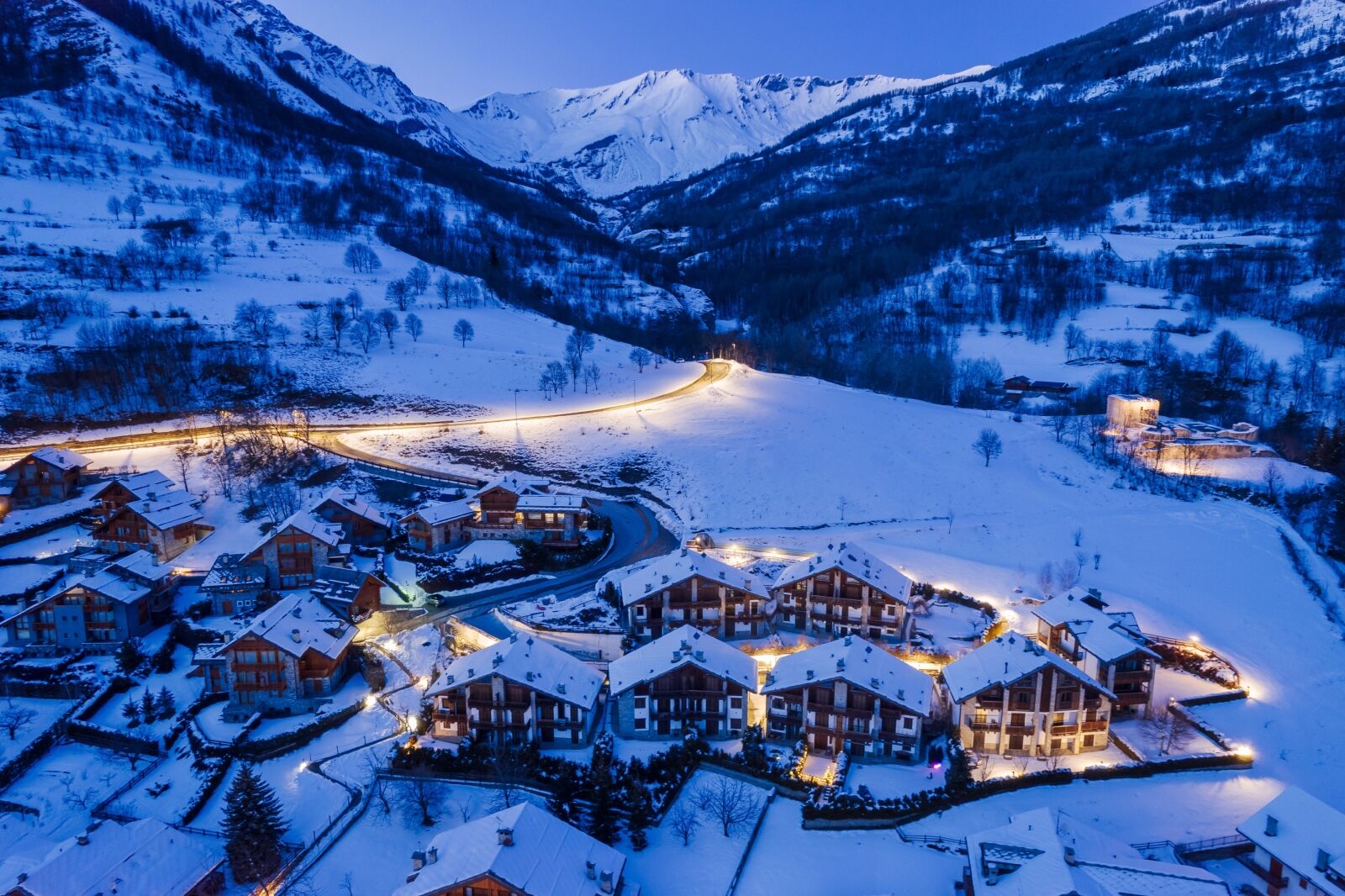 Bardonecchia in Italy - a snowy village in the swiss alps at night.